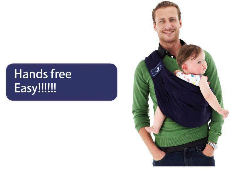 Man wearing navy blue infant carrying strap baby carrier holding a smiling baby hands free and easy