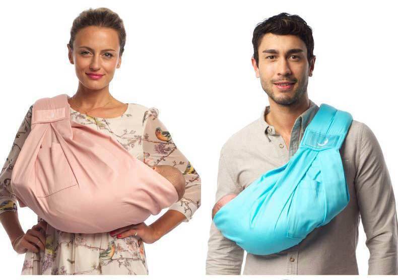 Woman and man wearing pink and blue infant carrying strap baby carriers holding babies comfortably