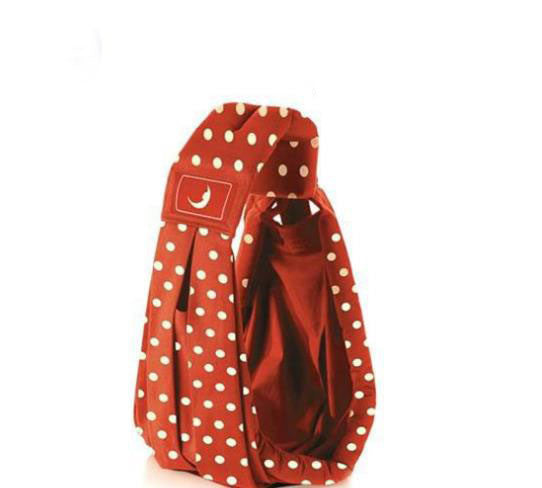 Red and white polka dot infant carrying strap baby carrier with padded shoulder support