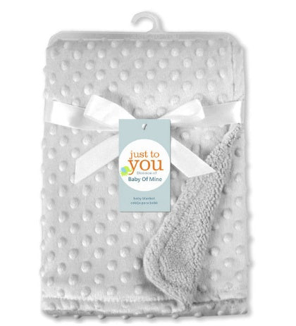 Soft newborn swaddle wrap in light gray with textured dots and cozy fleece backing
