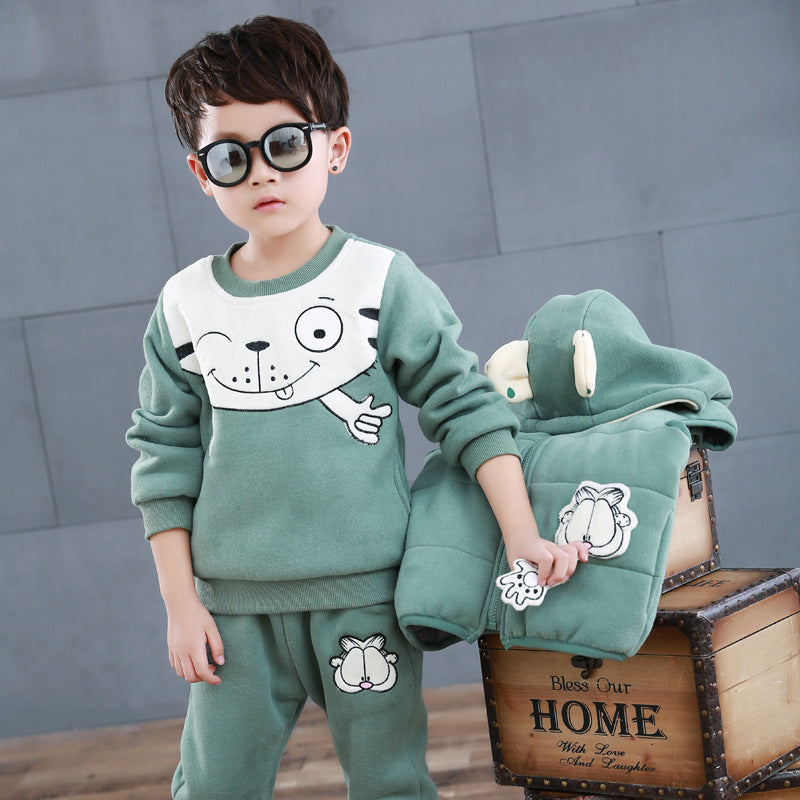 Toddler boy wearing green kids fleece sweater set with cartoon dog design holding matching jacket