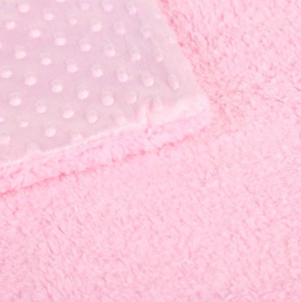 Close-up of soft newborn swaddle wrap in pink with textured and plush fabric for baby care