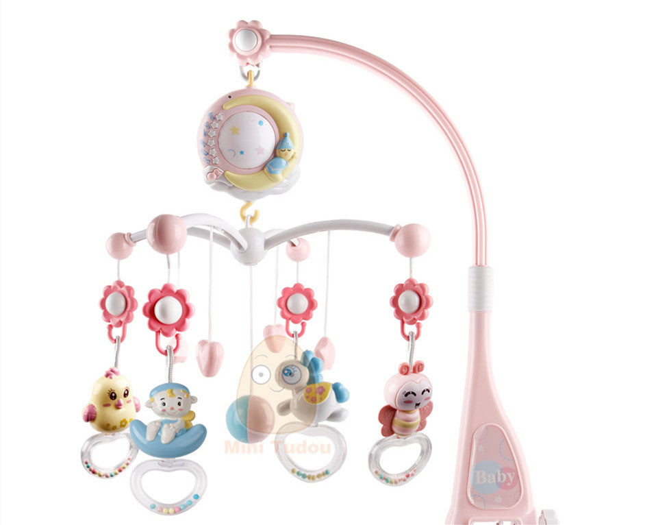 Pink infant soothing mobile with remote featuring hanging plush toys and heart-shaped rings