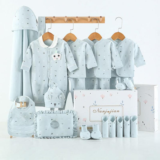 Newborn baby clothes gift set in light blue color with multiple clothing items and accessories neatly displayed
