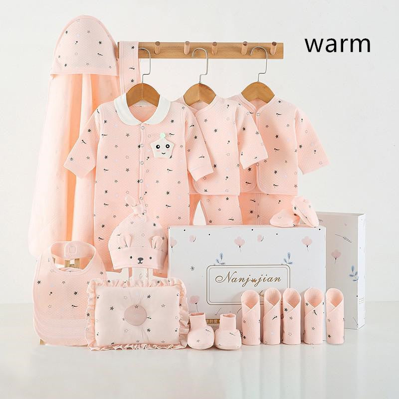 Newborn baby clothes gift set in soft pink includes bodysuit, hat, bib, booties, and blankets