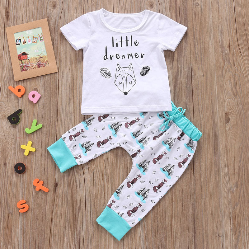 Newborn baby clothes set with white short sleeve shirt and patterned pants with blue cuffs