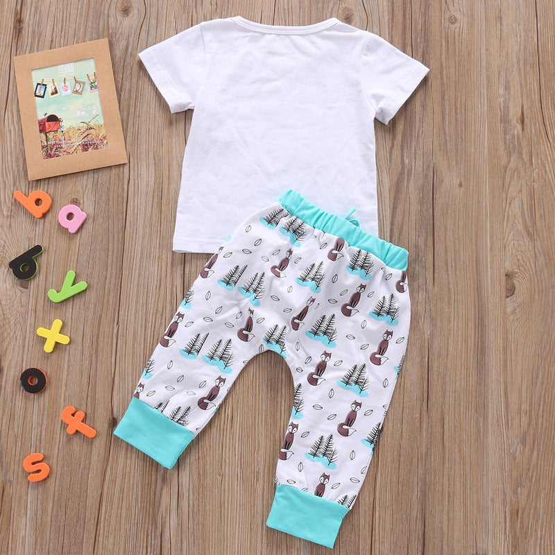 Newborn baby clothes set with white short sleeve shirt and printed pants with teal cuffs