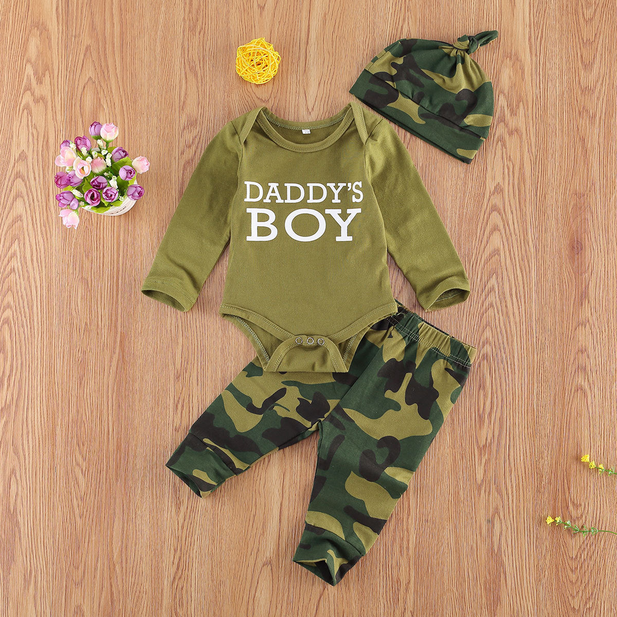 Newborn camo matching set with green long sleeve bodysuit saying Daddys Boy, camo pants, and matching camo hat