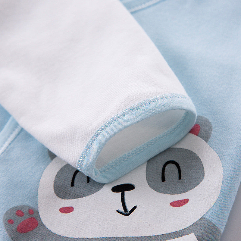 Close-up of blue and white baby clothing with panda print in newborn gift box