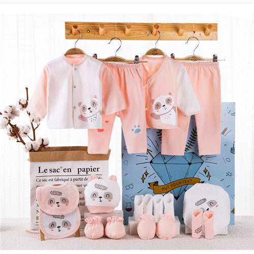 Newborn gift box with pink and white baby clothes and accessories featuring cute animal designs