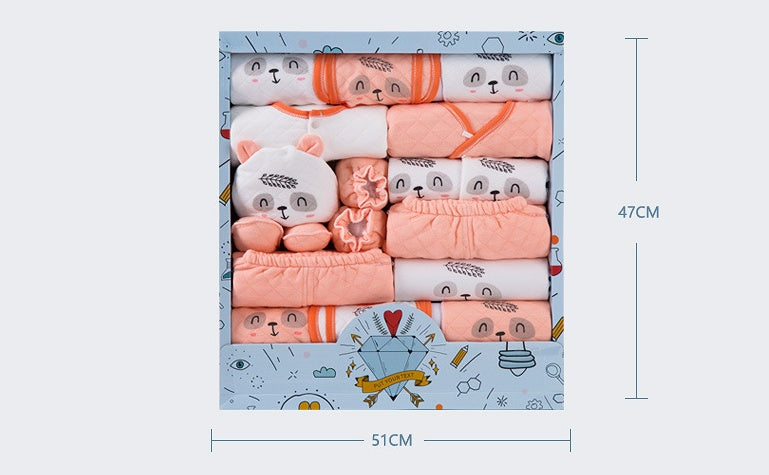 Newborn gift box with assorted baby clothes and accessories in peach and white colors