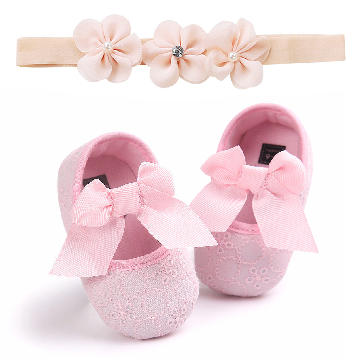 Pink baby shoes with bow featuring delicate lace design and matching floral headband