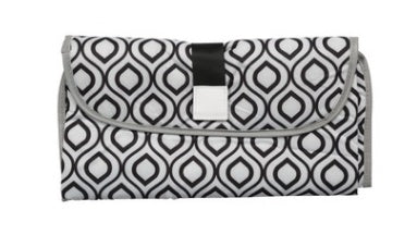 Folded portable baby changing pad with black and white geometric pattern and secure strap closure