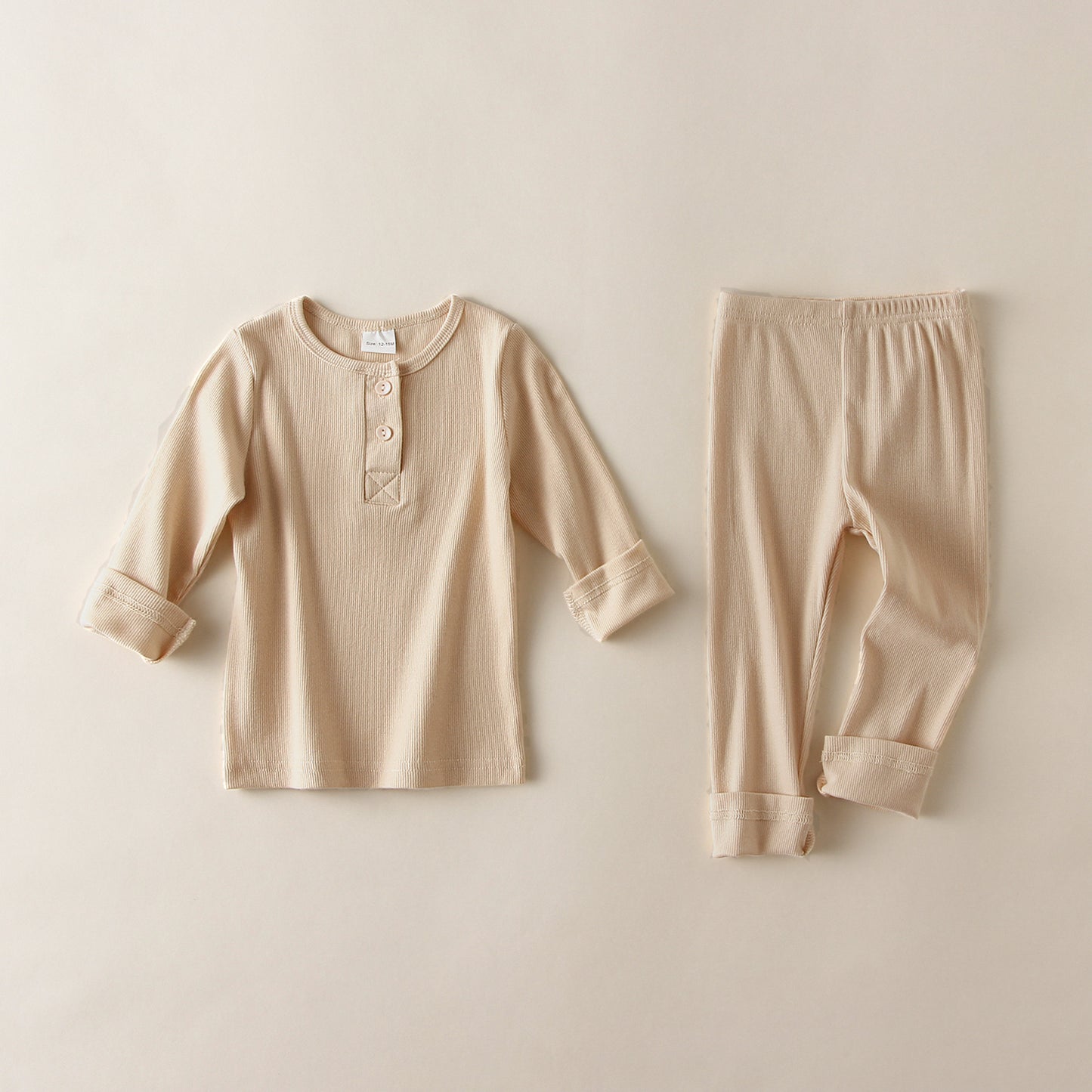 Beige soft cotton pajamas for toddlers with long sleeves and buttoned collar top and matching pants