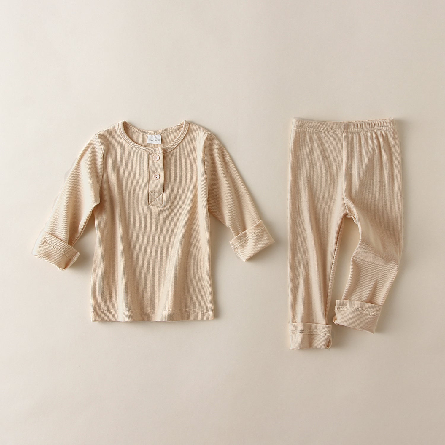 Beige soft cotton pajamas for toddlers with long sleeves and buttoned collar top and matching pants