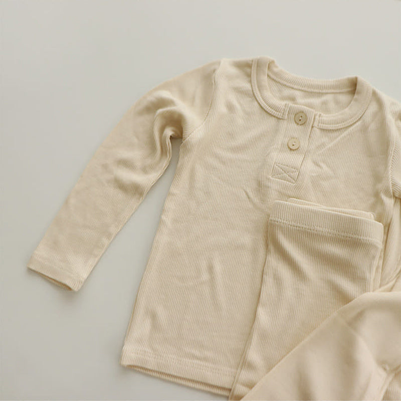 Beige soft cotton pajamas for toddlers with long sleeves and button closure