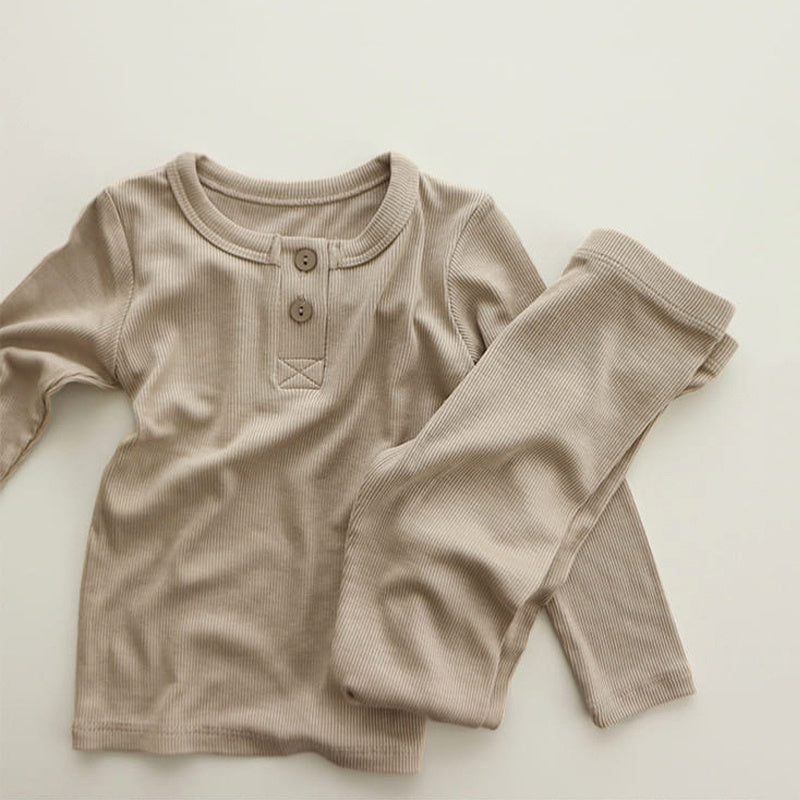 Beige soft cotton pajamas for toddlers with long sleeves and button details on top