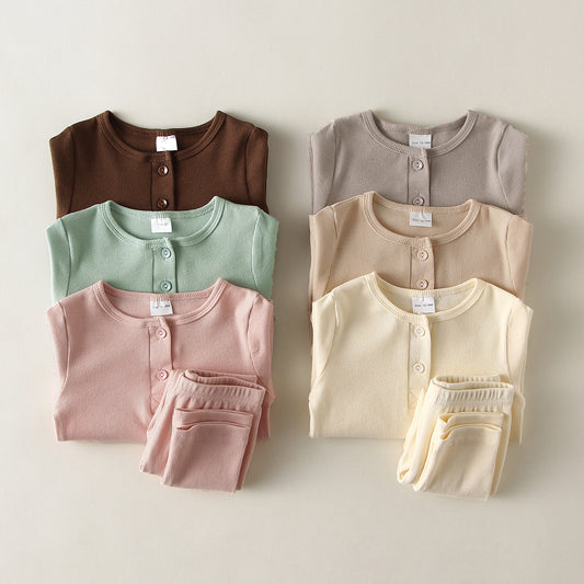 Set of soft cotton pajamas for toddlers in various muted colors including brown pink green gray beige and cream