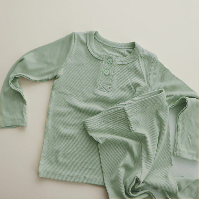 Soft cotton pajamas for toddlers in light green with long sleeves and button details
