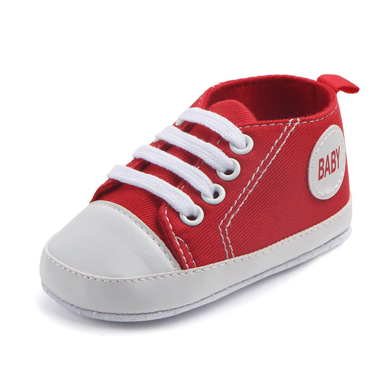 Red soft sole baby sneakers with white laces and toe cap for infant comfort