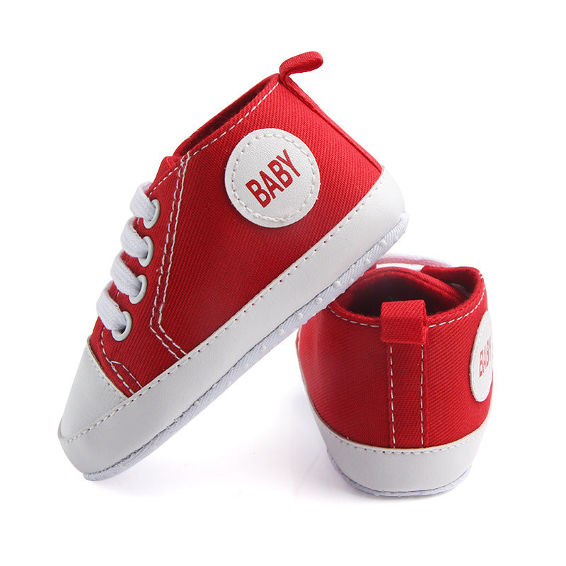 Red soft sole baby sneakers with white laces and baby patch on side for infants