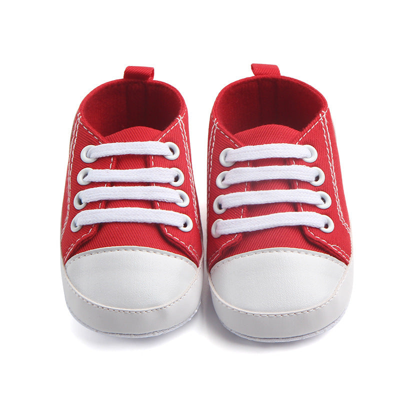 Red soft sole baby sneakers with white toes and laces for newborns and infants
