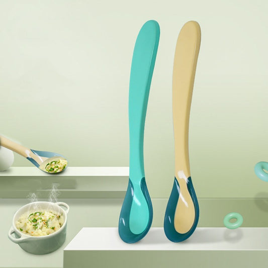 Two colorful soft tip spoons for babies in blue and beige with ergonomic handles for feeding