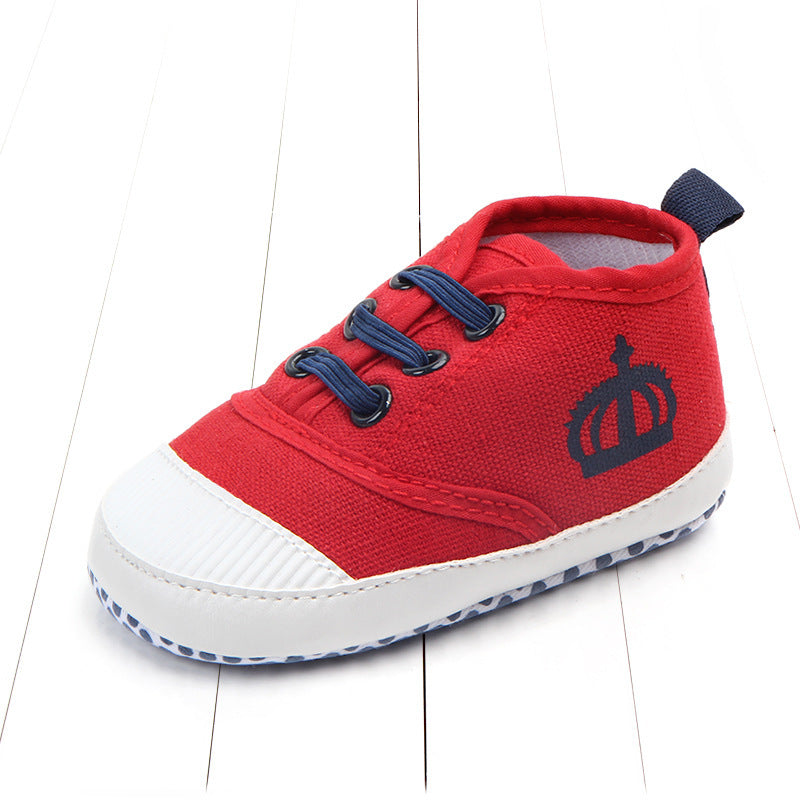 Red toddler canvas sneakers with blue laces and white rubber toe cap and sole for kids