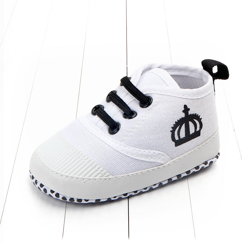 White toddler canvas sneakers with black laces and crown logo on side for toddlers