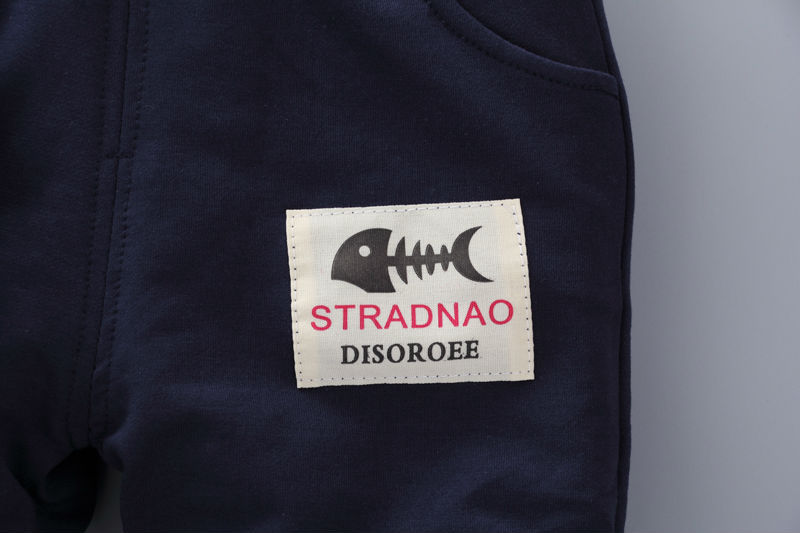 Close-up of navy toddler casual tracksuit with fishbone patch detail on pocket