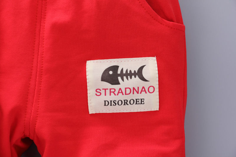Red toddler casual tracksuit close-up showing pocket with fishbone logo patch
