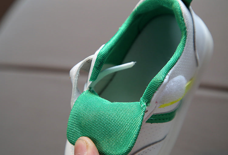 Close-up of green and white toddler velcro light up sneakers with adjustable straps