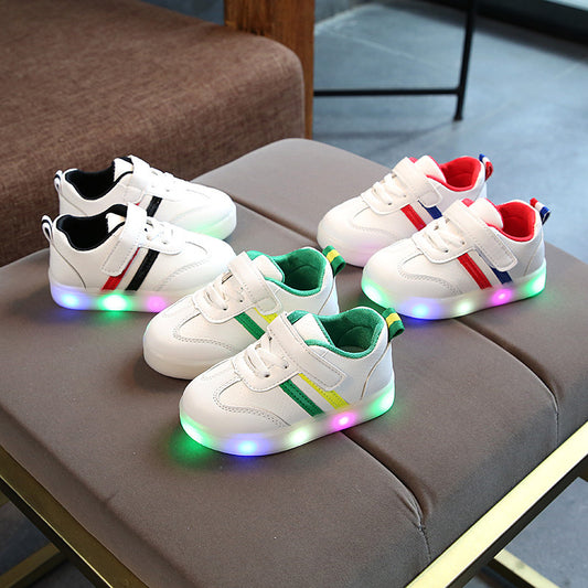 Toddler velcro light up sneakers in white with colorful LED soles and striped accents in green, black, and red