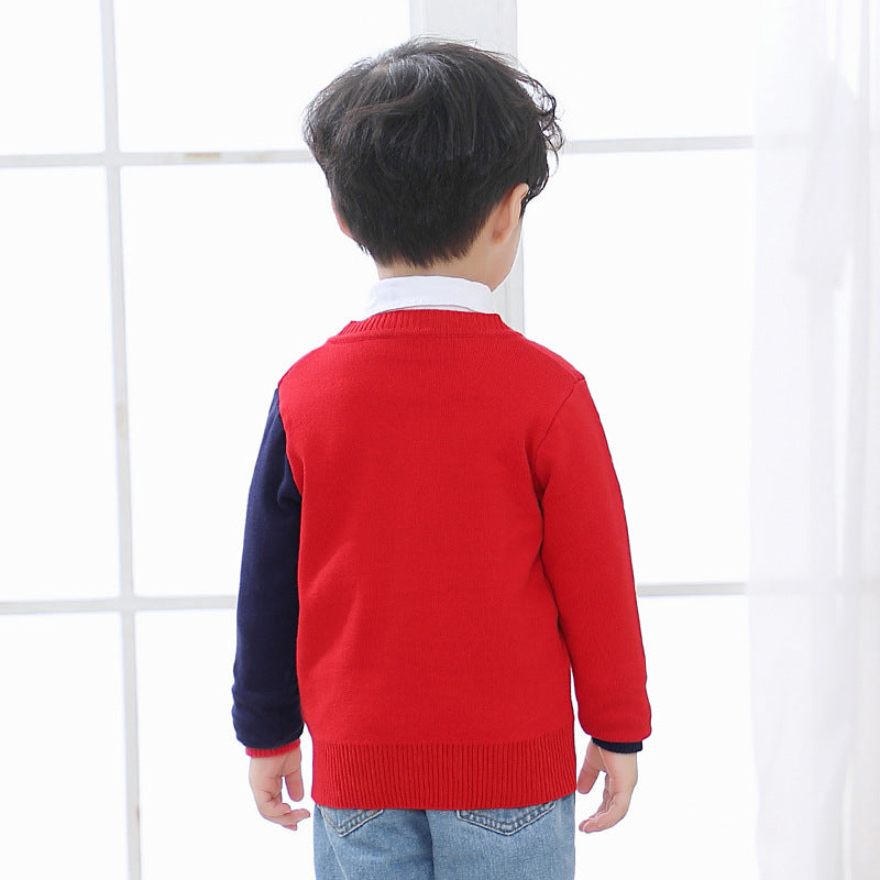 Back view of a child wearing a red and navy children's V-neck cardigan with jeans