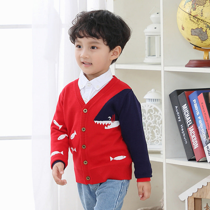 Children's V-neck cardigan in red and navy with fish design worn by a young boy