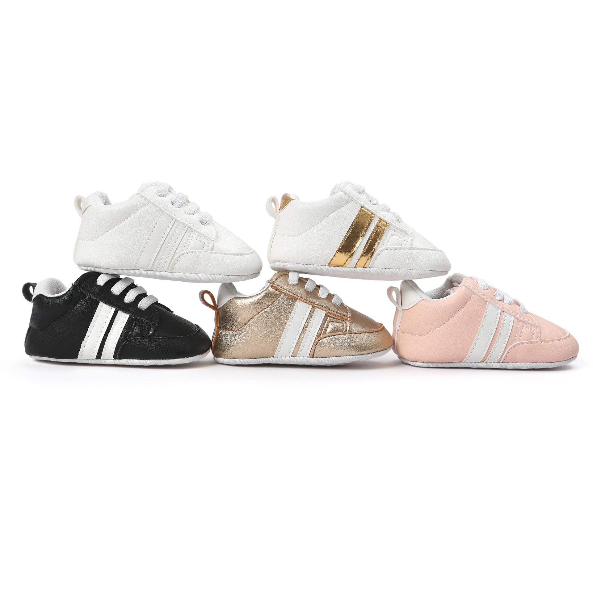 Colorful infant moccasin shoes in white, black, gold, and pink with sporty stripes