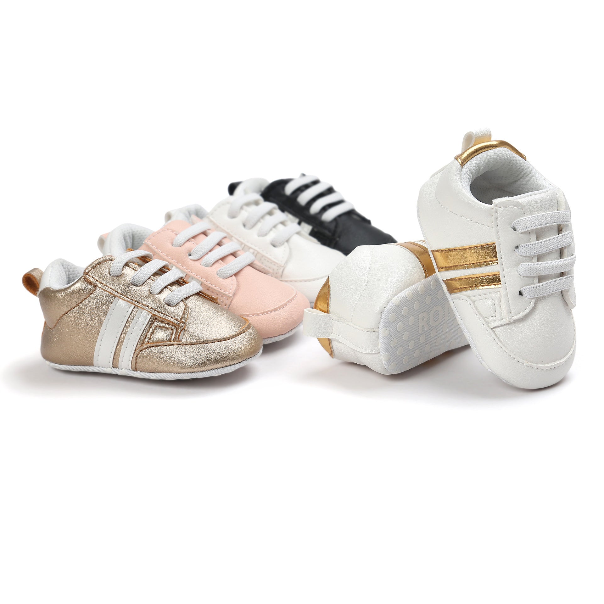 Variety of infant moccasin shoes in white, gold, pink, and black colors with lace-up design