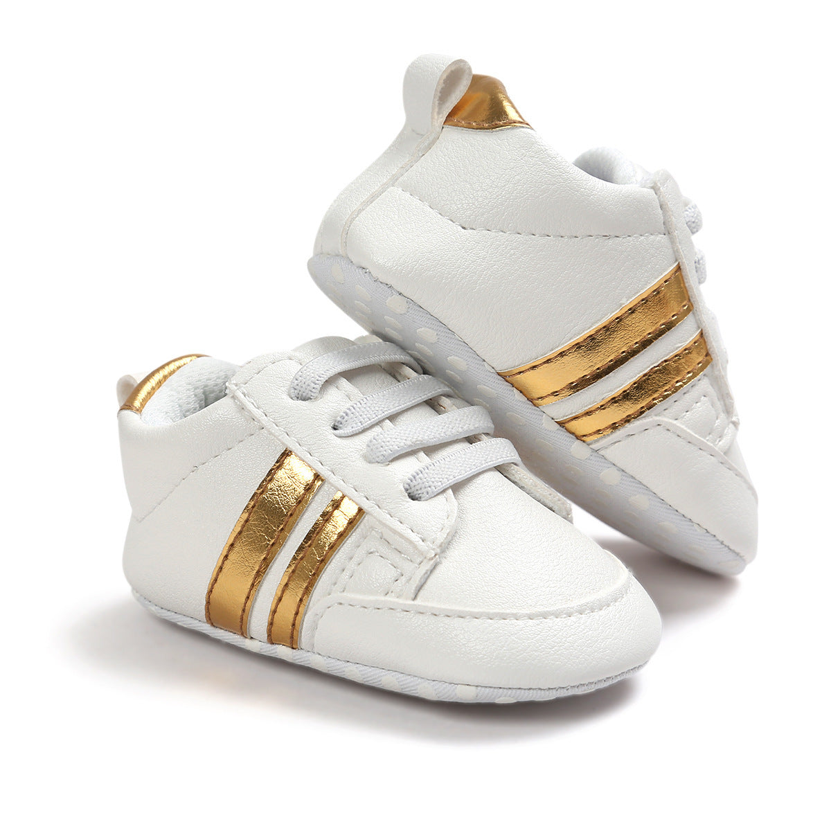 White infant moccasin shoes with gold stripes and soft soles for baby comfort