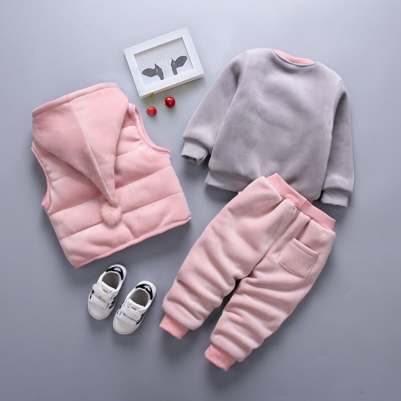 Warm toddler clothes for winter including pink hooded vest, gray sweatshirt, pink pants, and white shoes