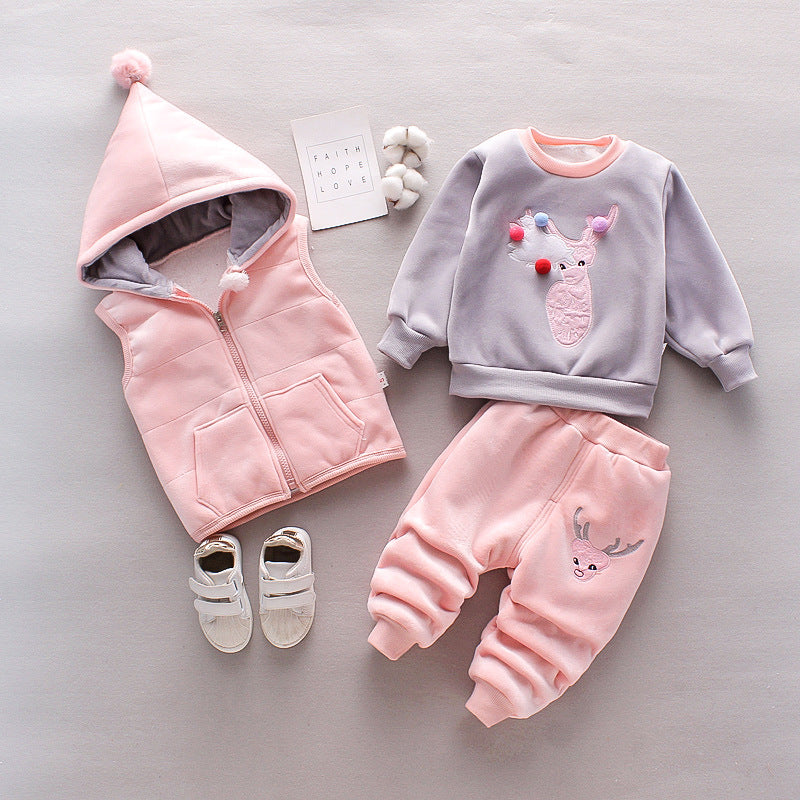 Warm toddler clothes for winter featuring a pink hooded vest, gray and pink sweatshirt, and pink pants with reindeer design